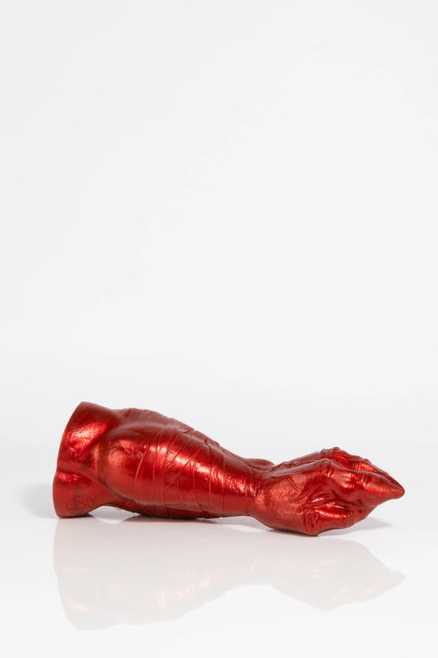 A product photo of a red dragon claw dildo lying down.
