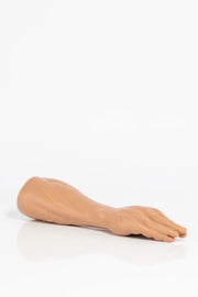 A product photo of a fist dildo lying down.