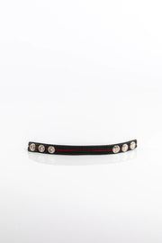 A product photo of a black cock ring with a red trim.