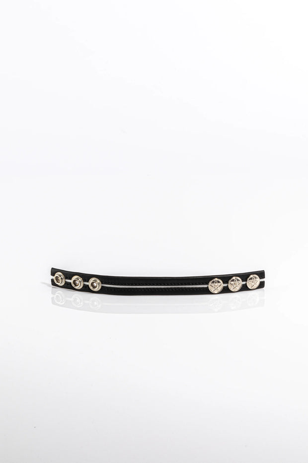A product photo of a black cock ring with white trim.