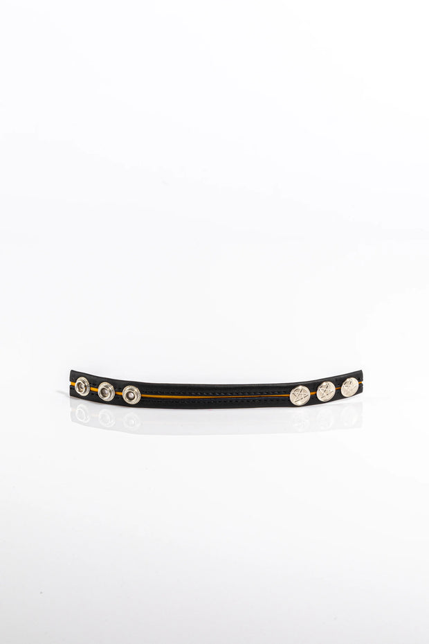 A product photo of a black leather cock ring with yellow trim.
