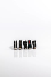 A product photo of five different coloured cock rings.