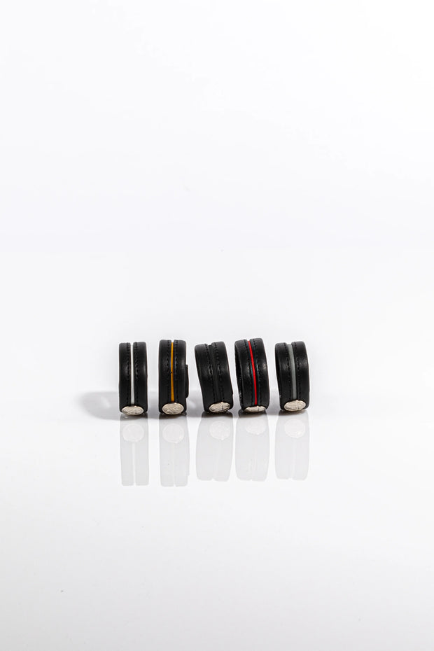 A product photo of five different coloured cock rings.