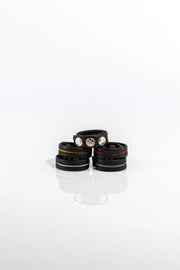 A product photo of five black and coloured cock rings. 