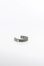 A product photo of a solid grey cock ring.