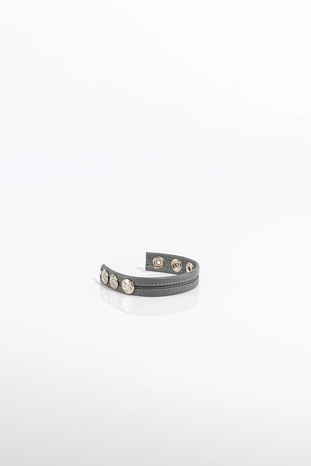 A product photo of a solid grey cock ring.