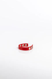 A product photo of a solid red cock ring.